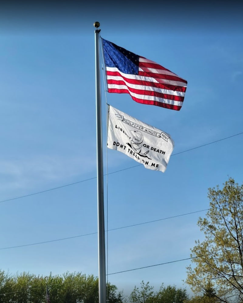 Load image into Gallery viewer, Tall 55-foot Lincoln Series aluminum flagpole with an external halyard, flying the American flag above a Culpeper Minute Men flag with the "Don't Tread on Me" text.