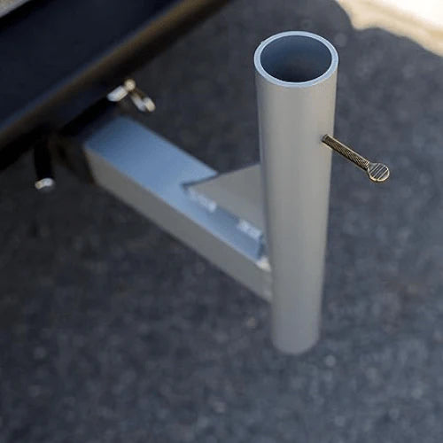 Load image into Gallery viewer, Close-up of the Flagpole Hitch Mount attached to a vehicle hitch, showing the locking pin and flagpole receiver.