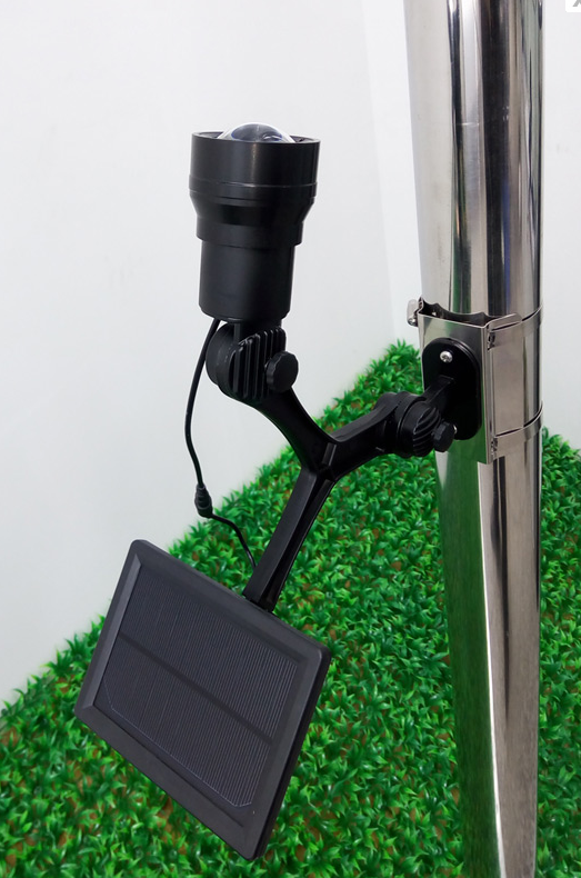 Load image into Gallery viewer, The Loyalty 350 Lux Solar Flagpole Light with its attached solar panel mounted securely to a silver flagpole.