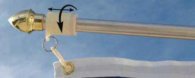 Load image into Gallery viewer, Close-up of the white Neverfurl anti-furling collar mechanism on a silver pole, attaching to a flag grommet against a blue sky.