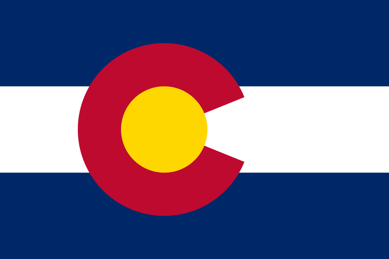 Load image into Gallery viewer, High-quality ceremonial Indoor Flag of Colorado with horizontal navy blue and white stripes. The flag is dominated by the bold, centered crimson "C" and golden sun disc emblem, representing the state's mountains, sunlight, and colored earth.
