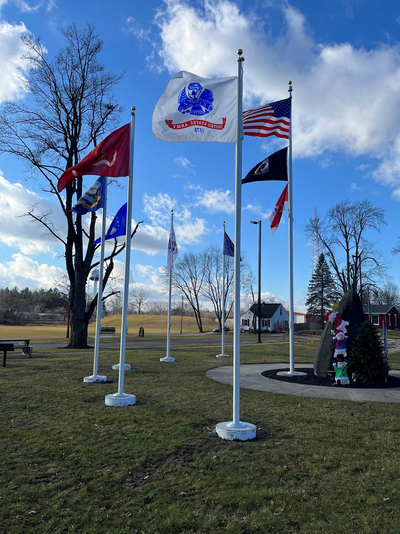 Load image into Gallery viewer, A group of aluminum flagpoles with a halyard system, displaying various flags, set against an outdoor backdrop.
