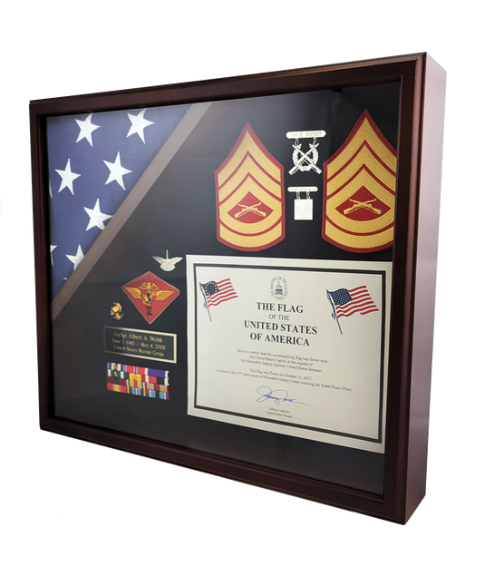 Angled view of a Capitol flag display case with a rich wood finish, organizing a triangular folded flag and various military awards and accouterments.