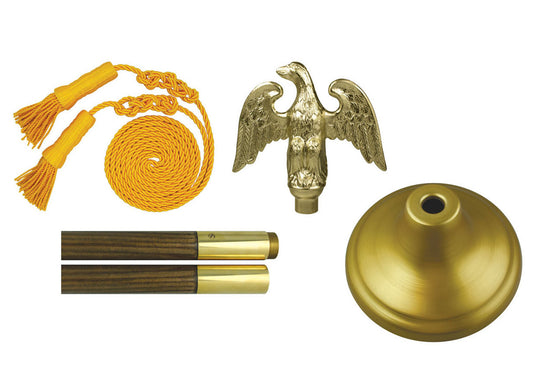 Deluxe indoor flagpole mounting set showing the components: a gold-plated eagle finial, gold cord and tassels, a gold-finished floor stand, and simulated wood-grain pole sections (8-foot, 1-1/8 inch diameter).