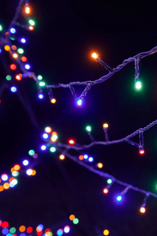 Close-up of the red, blue, green, and orange bulbs on the twisted strings of the Fairybell Multi-Color Flagpole Christmas Tree Light.