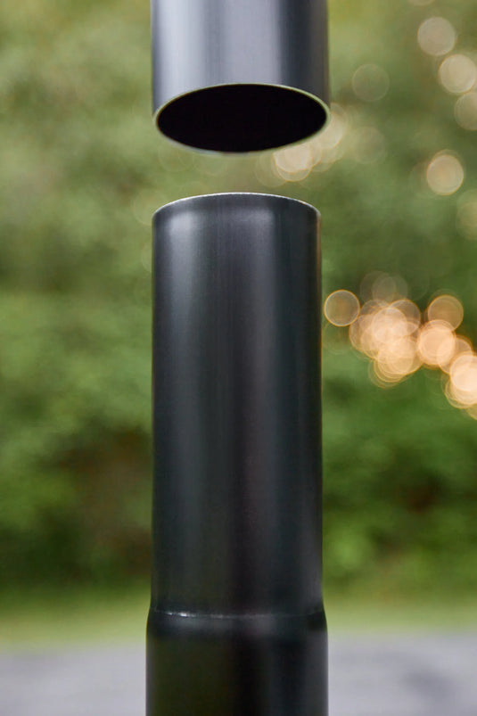 Close-up of two matte black aluminum sections of the Fairybell Sectional Aluminum Pole separating at a joint.