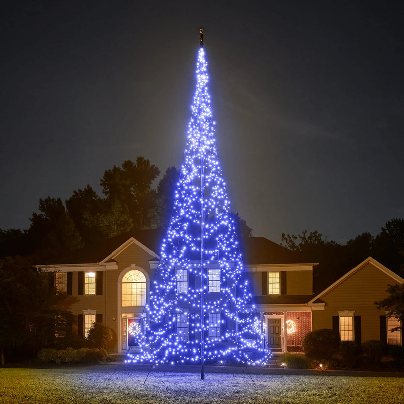 Load image into Gallery viewer, Tall outdoor Fairybell Single Color Flagpole Christmas Tree Light fully illuminated in vibrant blue next to a house.
