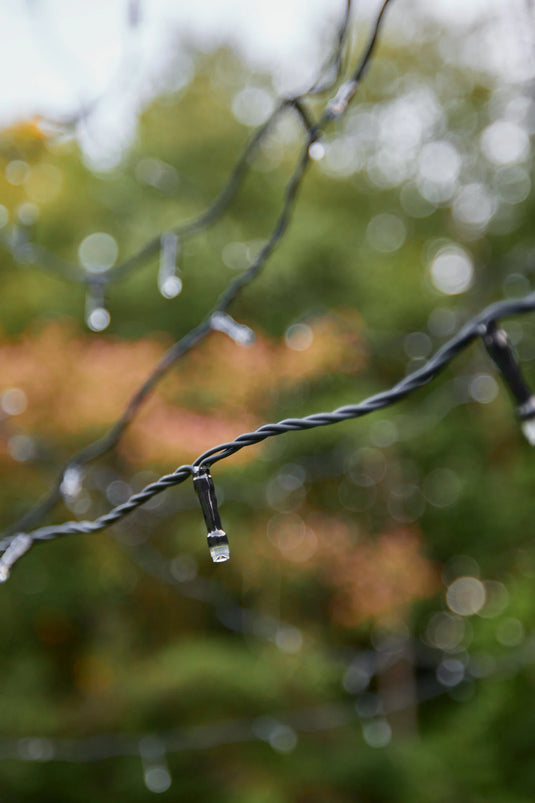 Close-up of the black wire string with individual LED bulbs on the Fairybell Single Color Flagpole Christmas Tree Light.