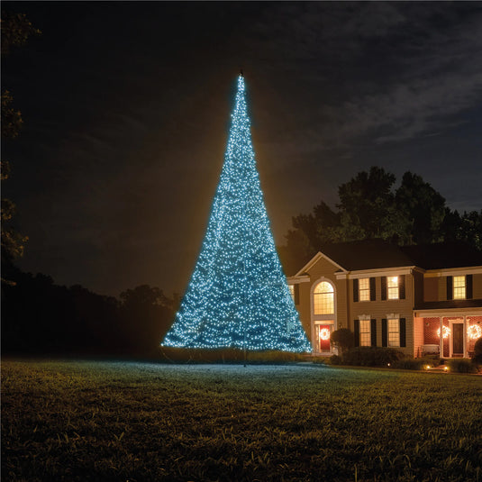 Fairybell Smart Magic Flagpole Christmas Tree Light illuminated in a cool, vibrant light blue color next to a house at night.