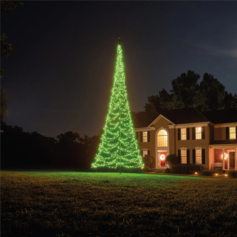 Load image into Gallery viewer, Fairybell Smart Magic Flagpole Christmas Tree Light illuminated in a pale mint green color in a residential yard.
