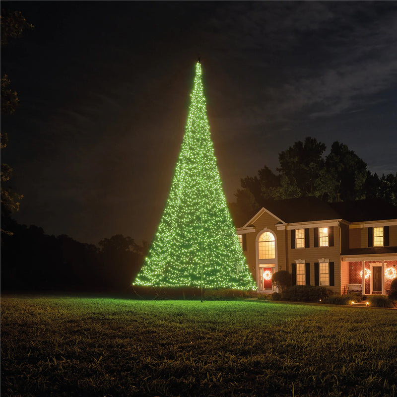 Load image into Gallery viewer, Fairybell Smart Magic Flagpole Christmas Tree Light illuminated in a warm yellowish-white color in a suburban front yard.

