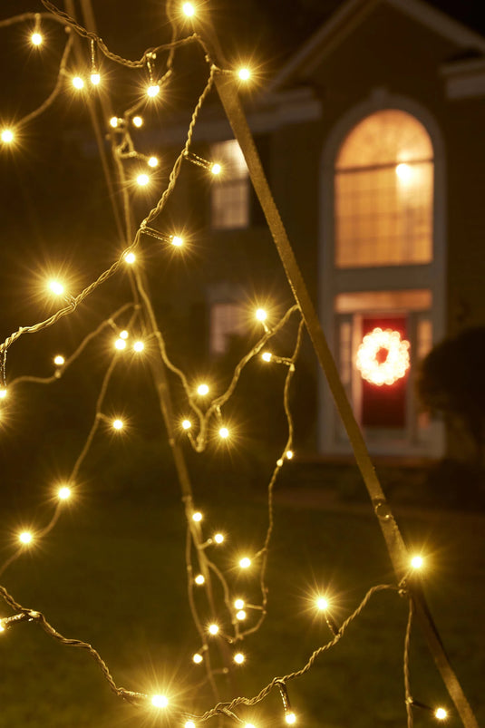 Close-up of the bright, star-like bulbs of the Fairybell Warm White Flagpole Christmas Tree Light against a dark background.