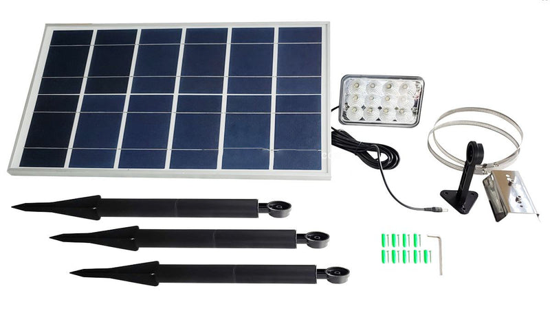 Load image into Gallery viewer, Full kit contents for the FPL Independence Solar Flagpole Light system. Components include the large solar panel, the rectangular LED light head, a connection cable, three black ground stakes for the light head, and mounting hardware/tools.
