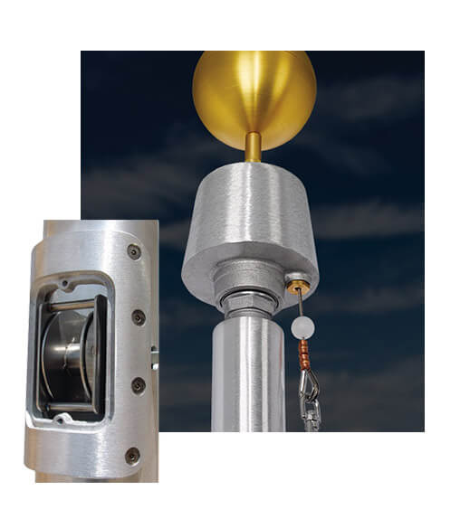 Close up image of internals of a flagpole, showing the winch system within along with a close up shot of the satin internal halyard truck unit on top of the pole.