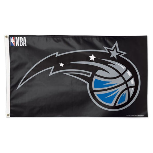 Deluxe Orlando Magic 3x5 flag featuring the team's official logo on a solid black field. The logo shows a silver and blue basketball trailing a silver streak with two small white stars and a large silver star on the end. The NBA logo is visible in the top left corner.