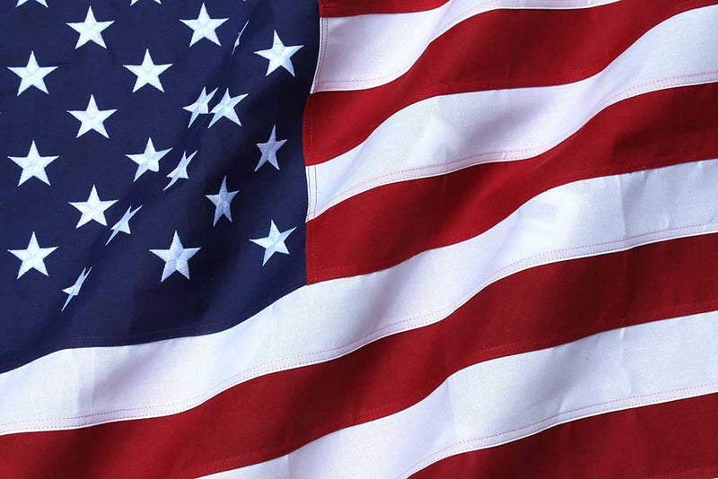 Load image into Gallery viewer, Close-up view of an American flag made of heavy-duty polyester, showing detailed stripes and stars.
