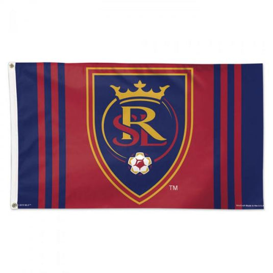 A rectangular flag featuring the Real Salt Lake emblem with a shield design, predominantly in red, with a blue and yellow stripe across the top. The flag has a white background and is branded with the 'RSL' initials.