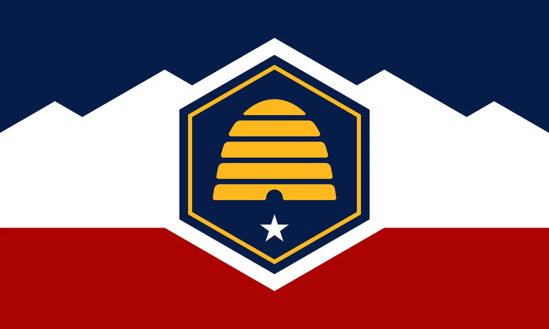Load image into Gallery viewer, Utah state flag featuring a stylized beehive symbolizing industry, with a white star below and a blue, white, and red field representing unity and heritage.

