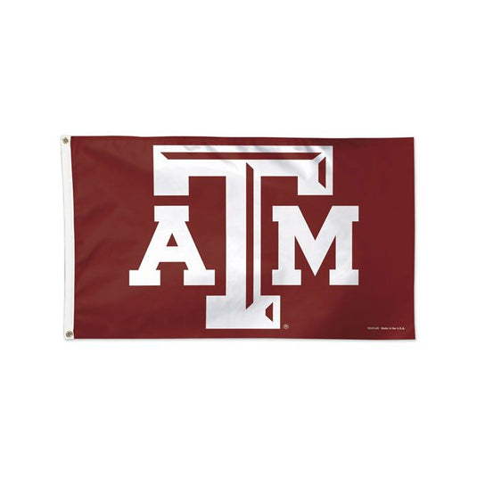 A rectangular Texas A&M Aggies flag with a maroon background and white text forming the logo 'ATM'.