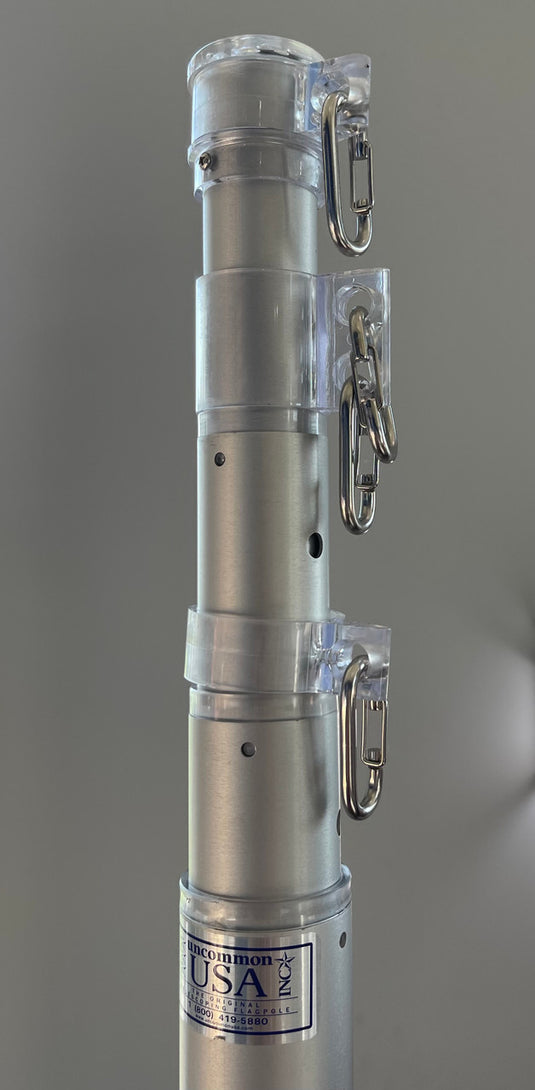 Close-up of the silver aluminum upper sections of The Original Telescoping Flagpole Kit showing the clear swivel collars and snap clips.