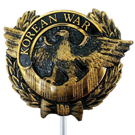 Gold and black thermoplastic Korean War memorial marker featuring a central eagle with wings spread, framed by a laurel wreath and mounted on a small rod.