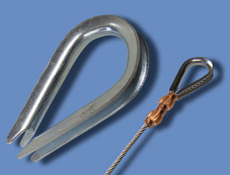 Comparison shot showing a large galvanized steel Thimble and a smaller thimble secured to wire cable with copper sleeves.