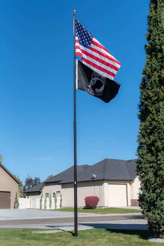 Black Titan Telescoping Flagpole Kit flying both the American flag and the black POW/MIA flag together.