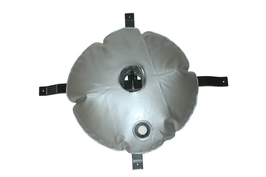 Silver water weight bag secured to a black flagpole base, showing the central hole fitted around the stand and the four black mounting straps extending outwards.