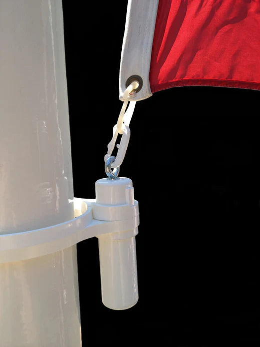 Load image into Gallery viewer, Close-up of the white weight ring for fiberglass flagpoles mounted on a white pole, with the weighted tube hanging down and clipped to the grommet of a red flag.
