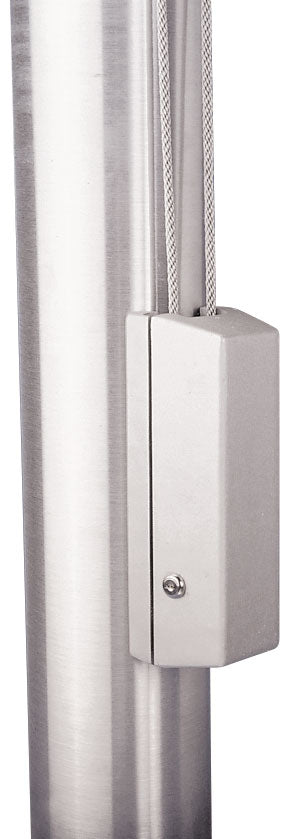 Close-up view of a silver, brushed aluminum Flagpole Cleat Cover Box installed on a stainless steel pole. The cover conceals the internal cleat, with the steel halyard cable visible exiting through the top slot.