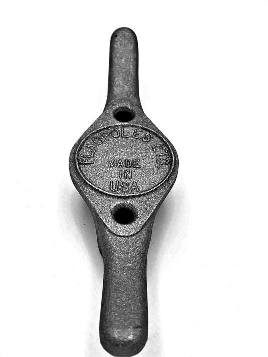 Heavy Duty Cast Aluminum Flagpole Cleat in a matte black or very dark grey finish. The American-made cleat has two symmetrical mounting holes and the text "MADE IN USA" clearly visible in the center oval.