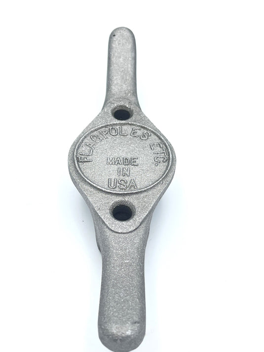 Heavy-duty, cast aluminum Flagpole Cleat with a textured silver finish. The cleat is centered by an oval plate stamped with "MADE IN USA" and includes two screw holes for mounting the halyard hardware.