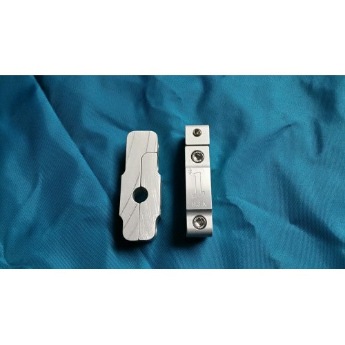 Two disassembled pieces of the silver aluminum Swiveler Boat Flagpole Rail Clamp showing the mounting screws.
